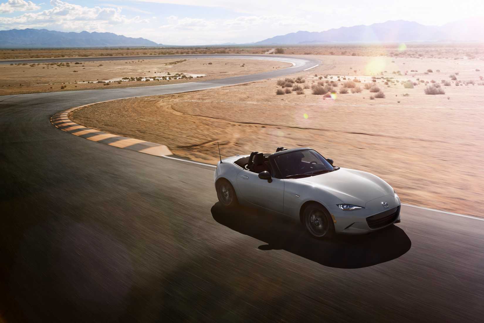 2026 Mazda MX-5 Miata driving on a track in the desert. 