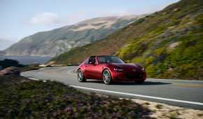 Red 2026 Mazda MX-5 Miata on a coastal highway