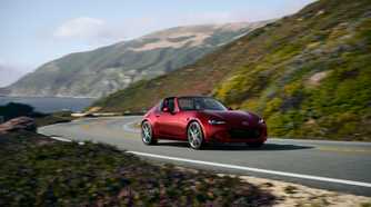Red 2026 Mazda MX-5 Miata on a coastal highway