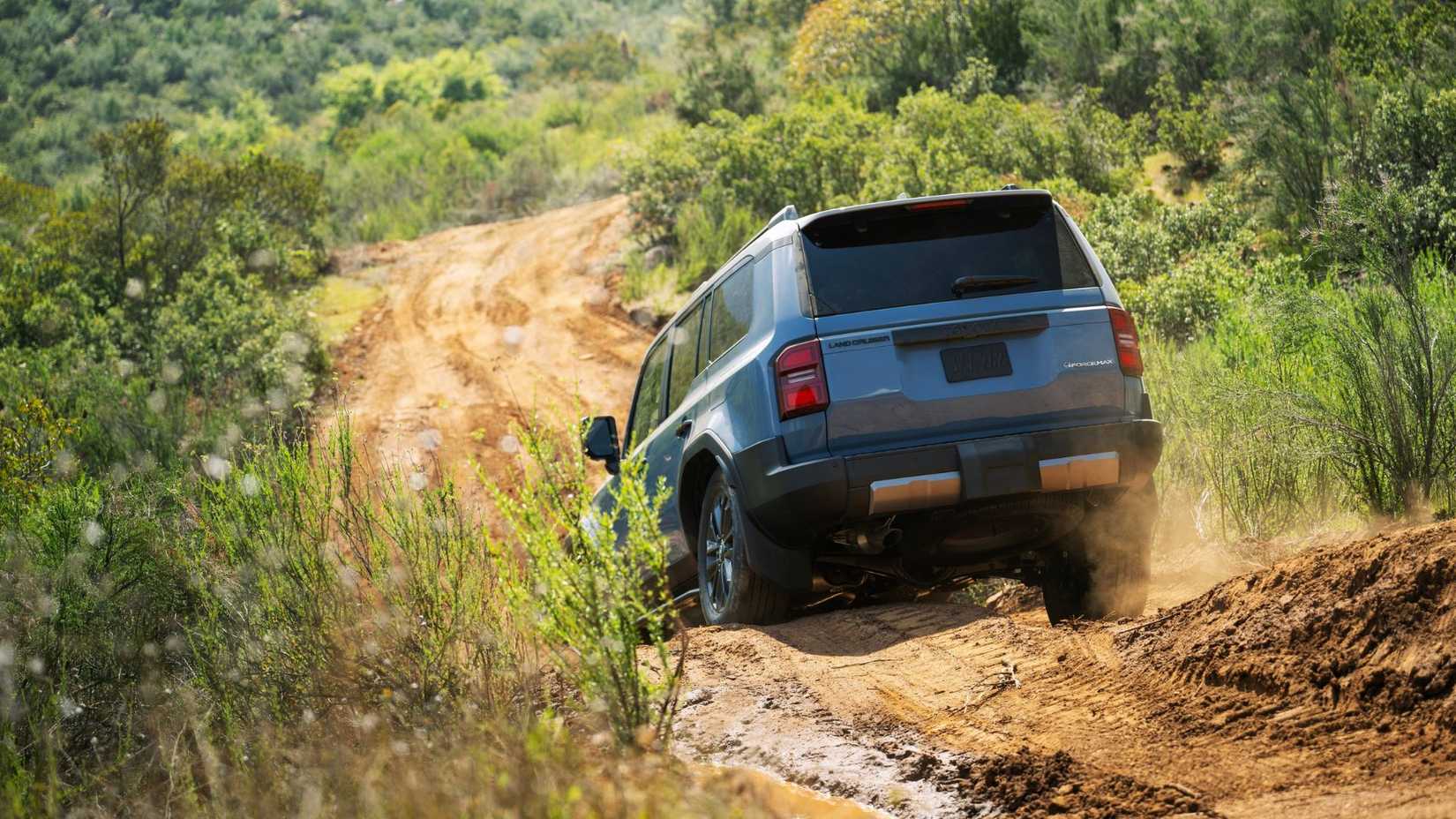 Dynamic rear-end shot of a blue 2026 Land Cruiser.
