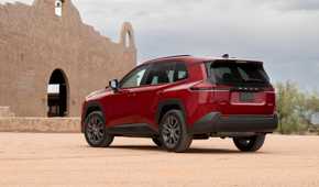 Static rear 3/4 shot of a red 2026 Toyota RAV4 HEV XLE Premium.