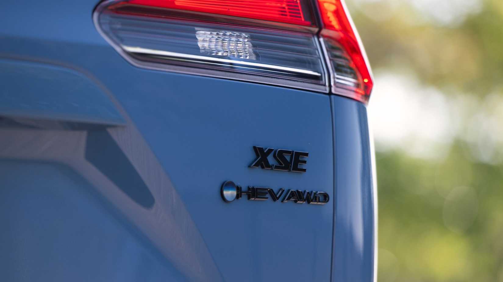 Close-up shot of the badging on the trunk lid of a blue 2026 Toyota Corolla Cross Hybrid XSE AWD.