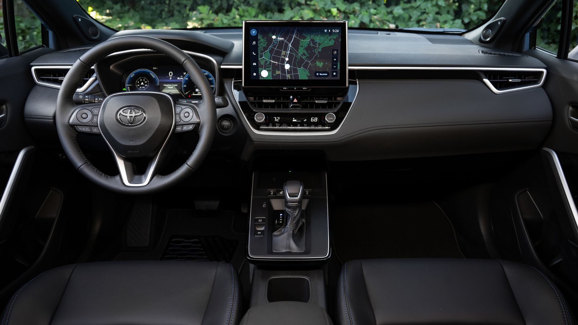 Shot inside the cabin of a 2026 Toyota Corolla Cross Hybrid XSE AWD, showing the front seats and dashboard.