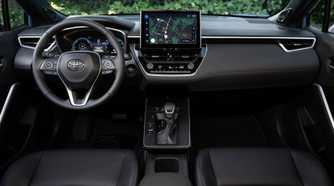 Shot inside the cabin of a 2026 Toyota Corolla Cross Hybrid XSE AWD, showing the front seats and dashboard.