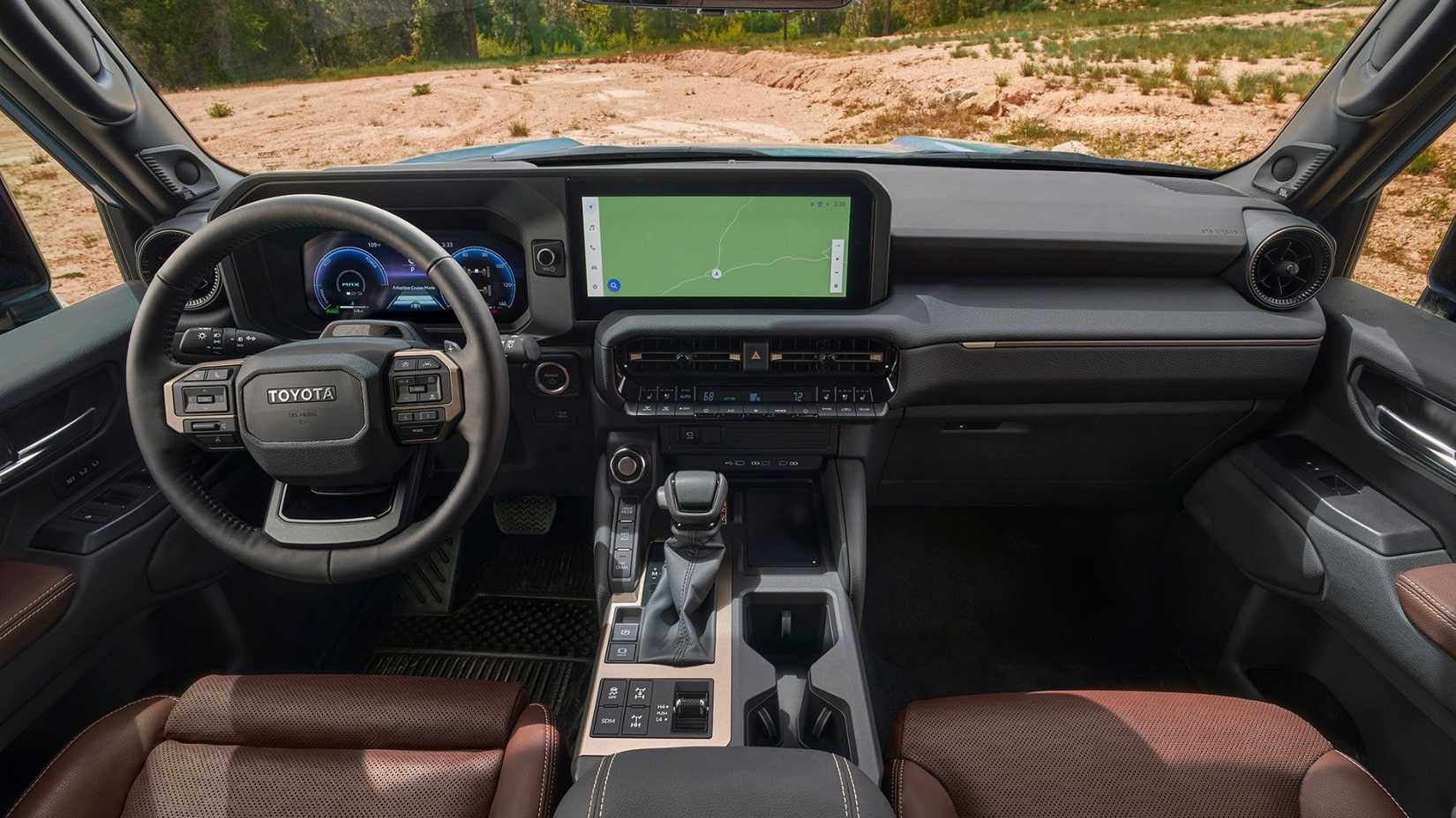 Shot inside the cabin of a 2026 Toyota Land Cruiser, showing the front seats and dashboard.