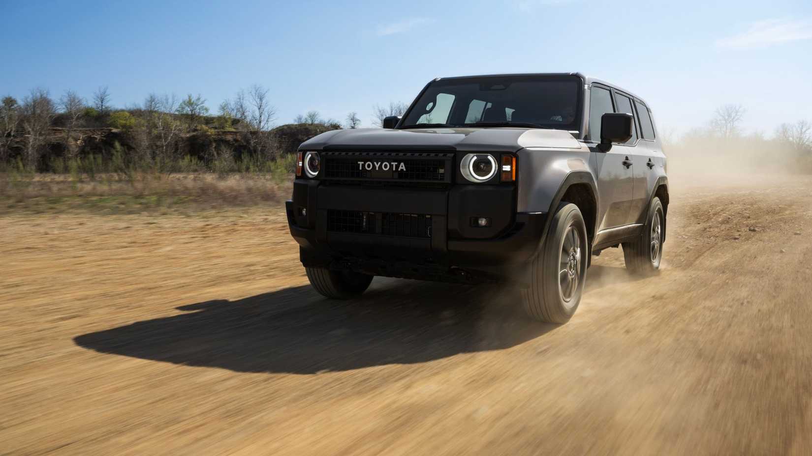 Dynamic front 3/4 shot of a gray 2026 Toyota Land Cruiser 1958.