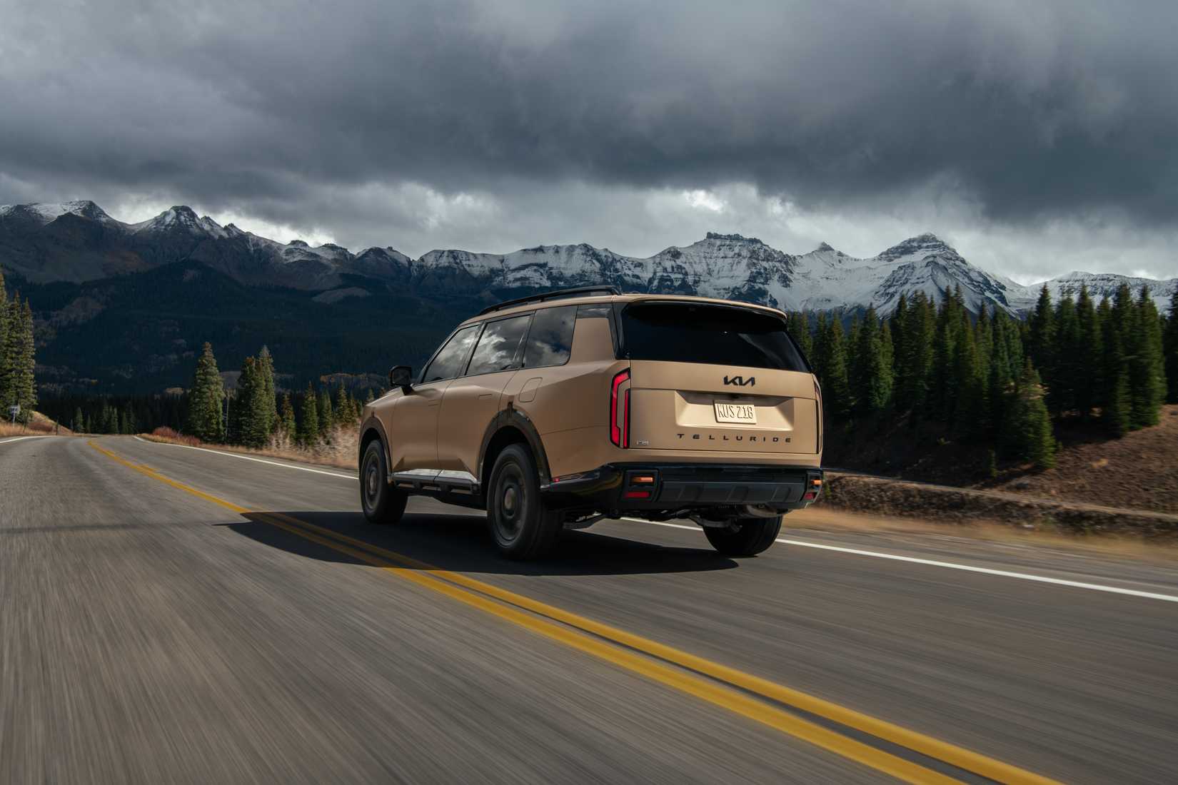 2027 Kia Telluride X-Pro driving on a mountain highway