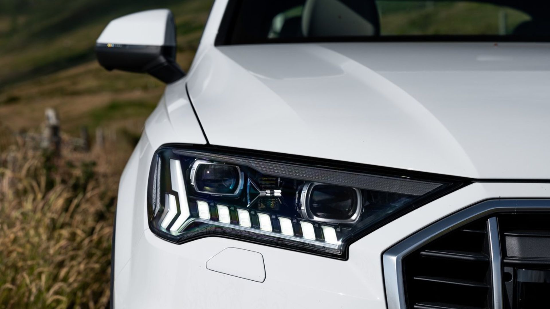 Close-up shot of the headlight on a white 2020 Audi Q7.
