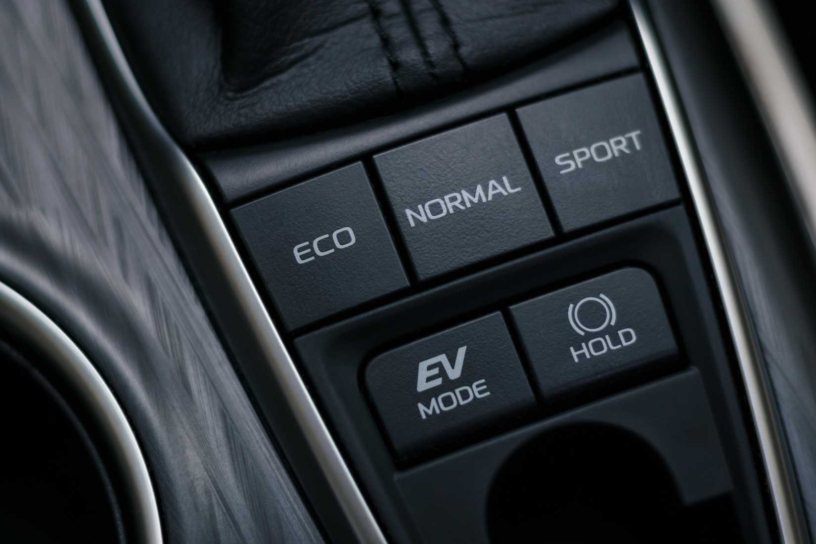 An image of a car's center console where the driving mode buttons eco, normal, and sport live.