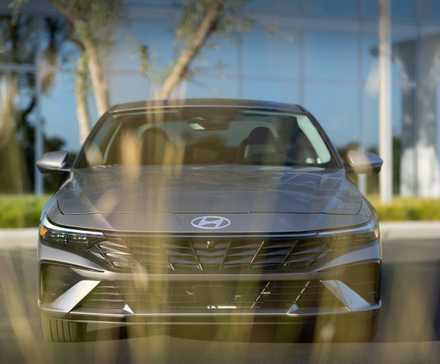 Gray 2026 Hyundai Elantra parked in front of an office building