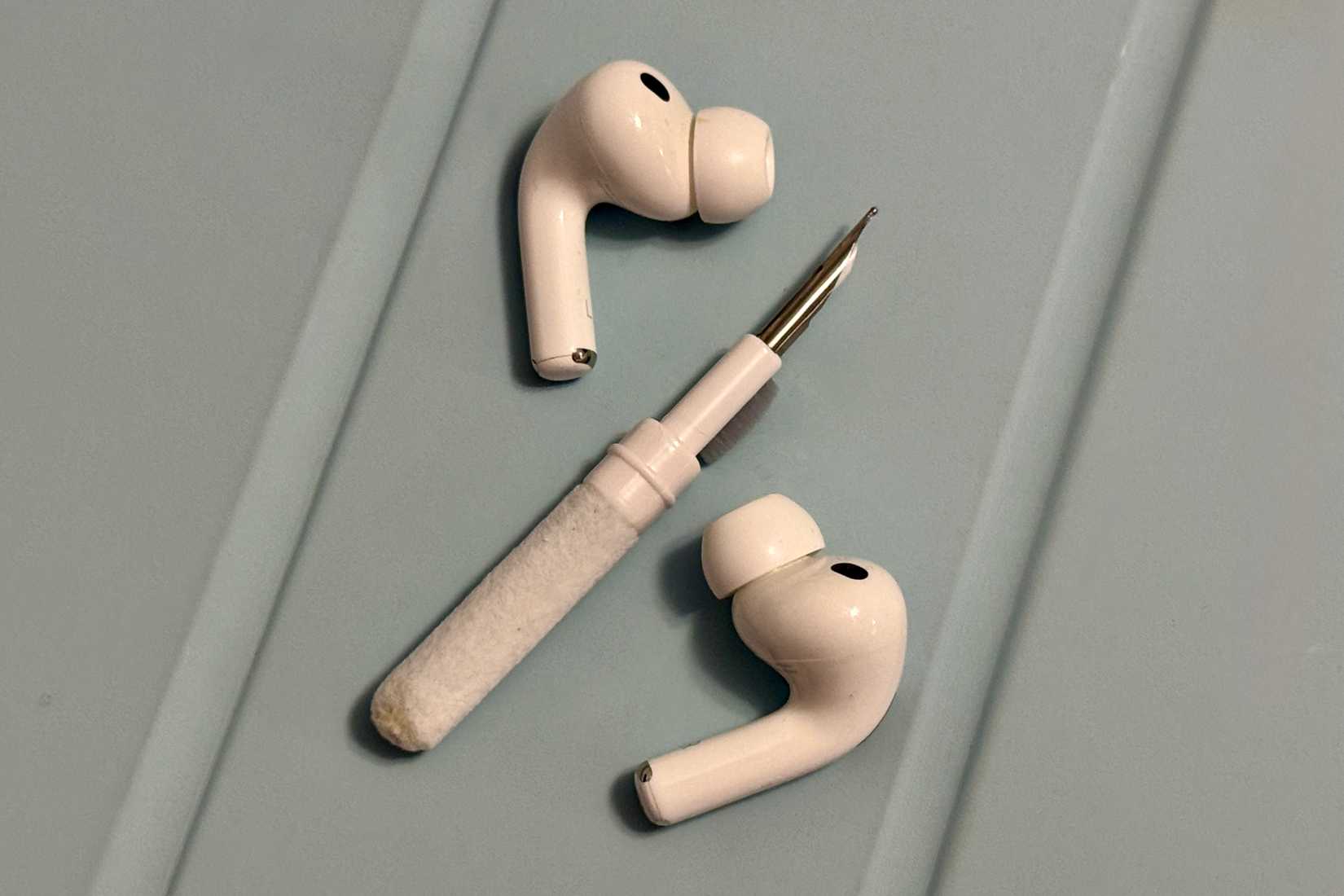 AirPods Pro 3 with a cleaning kit.