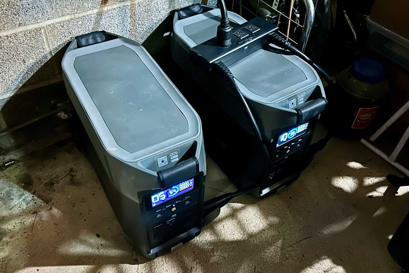 Two electric generators inside a garage.