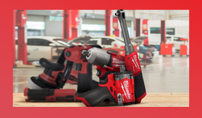Milwaukee tools in sharp focus on a workbench, with blurred Snap-on tools and a mechanic's garage in the background.
