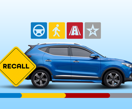 A blue SUV on a light blue background with a large yellow warning triangle in the foreground that says 'RECALL'