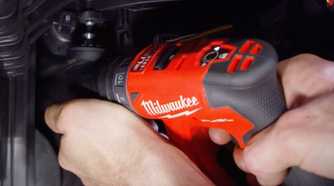 person using the Milwaukee installation driver