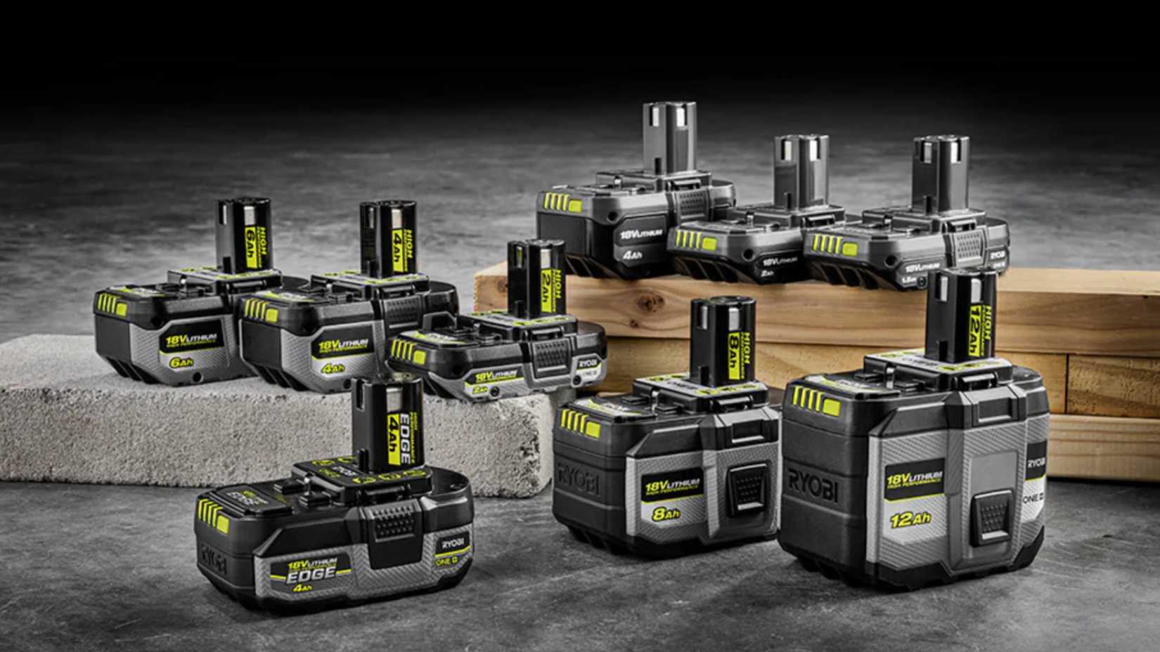 pile of Ryobi battery packs on a floor