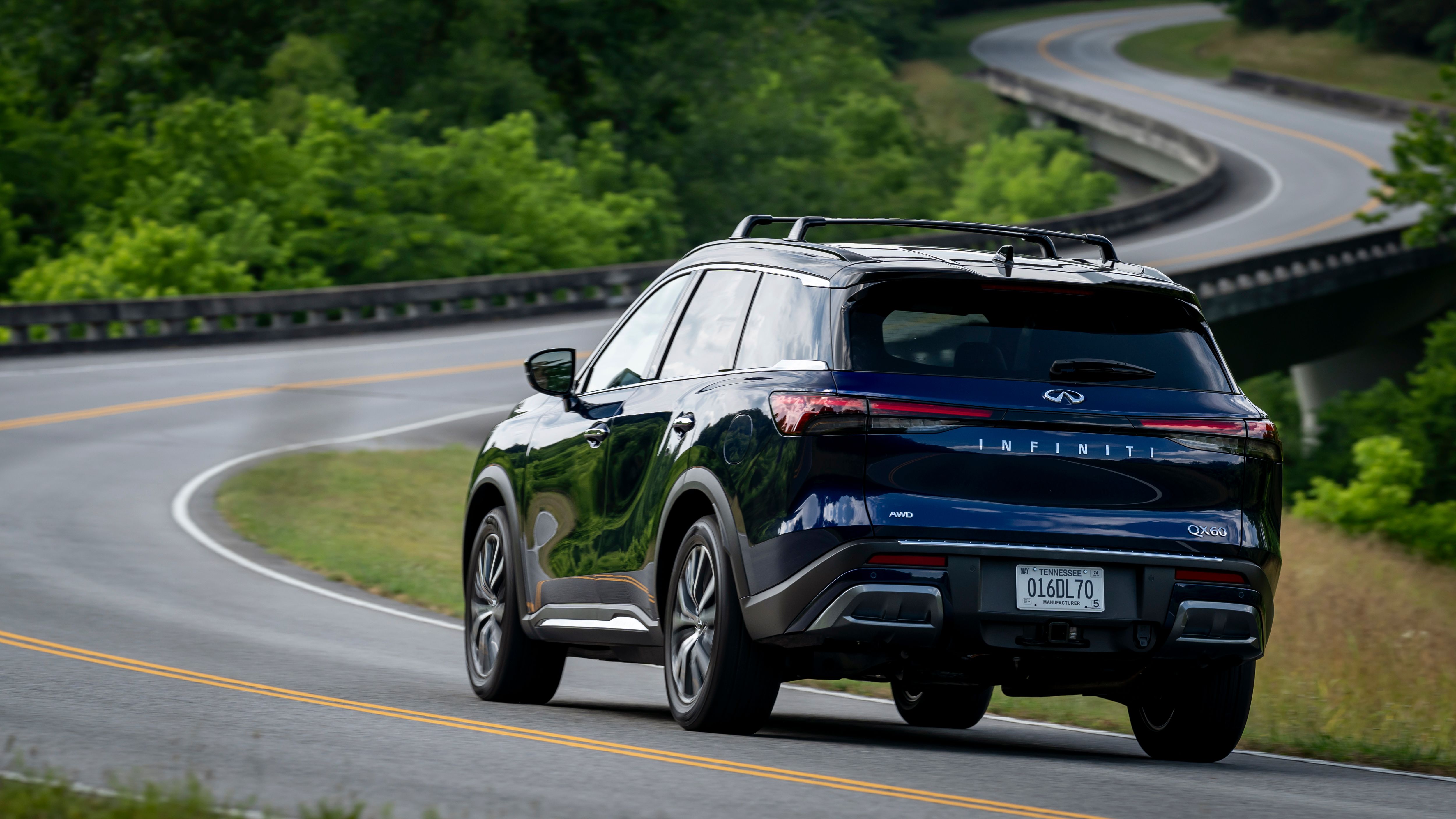 Rear profile of a 2024 Infiniti QX60 driving down the highway