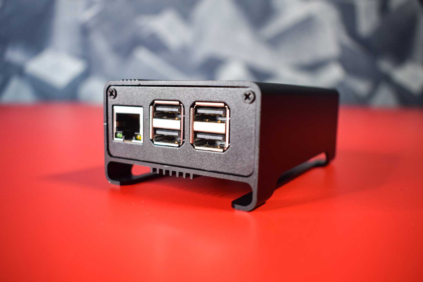 A RaspberryPi in an all-metal case with heatsink fins visible on the bottom.