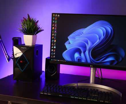 A Windows 11 PC desk setupn with moody lighting and a desktop with several columns of icons.