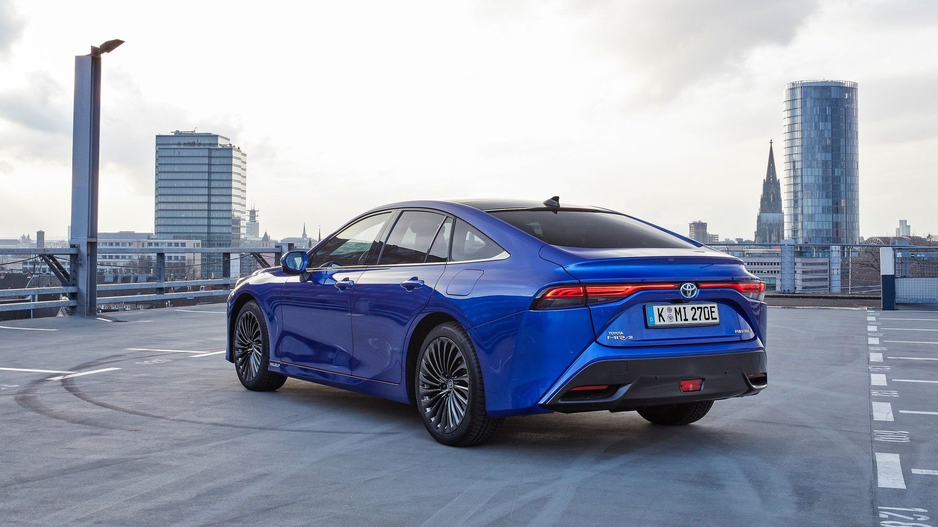 Rear 3/4 shot of a 2022 Toyota Mirai parked on top of a parking garage