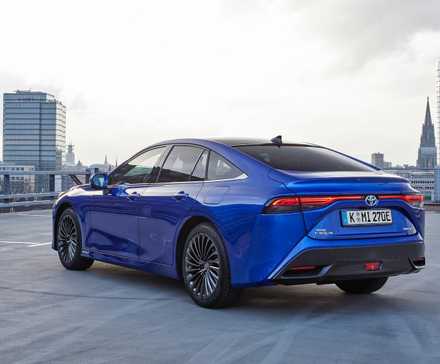 Rear 3/4 shot of a 2022 Toyota Mirai parked on the top of a parking garage