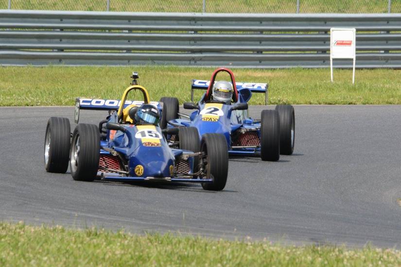 Two small cart race cars on a track