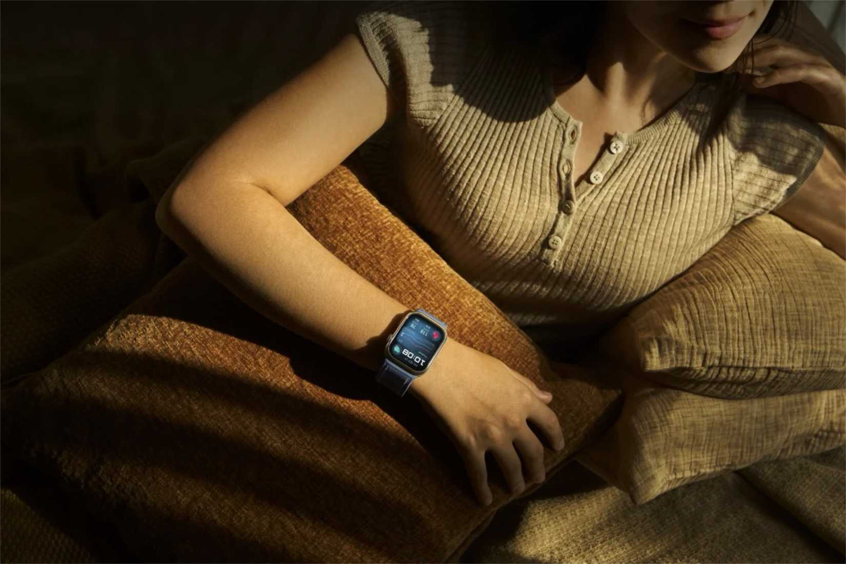 Huawei smartwatch on a wrist for a person relaxing.