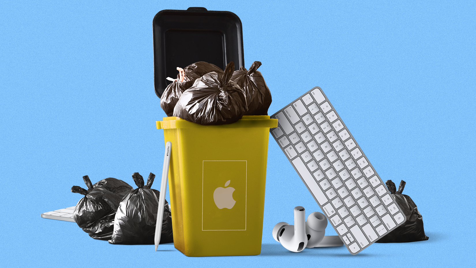 Yellow trash bin with an Apple logo overflowing with black garbage bags, surrounded by a Magic Keyboard, Apple Pencil, and AirPods.