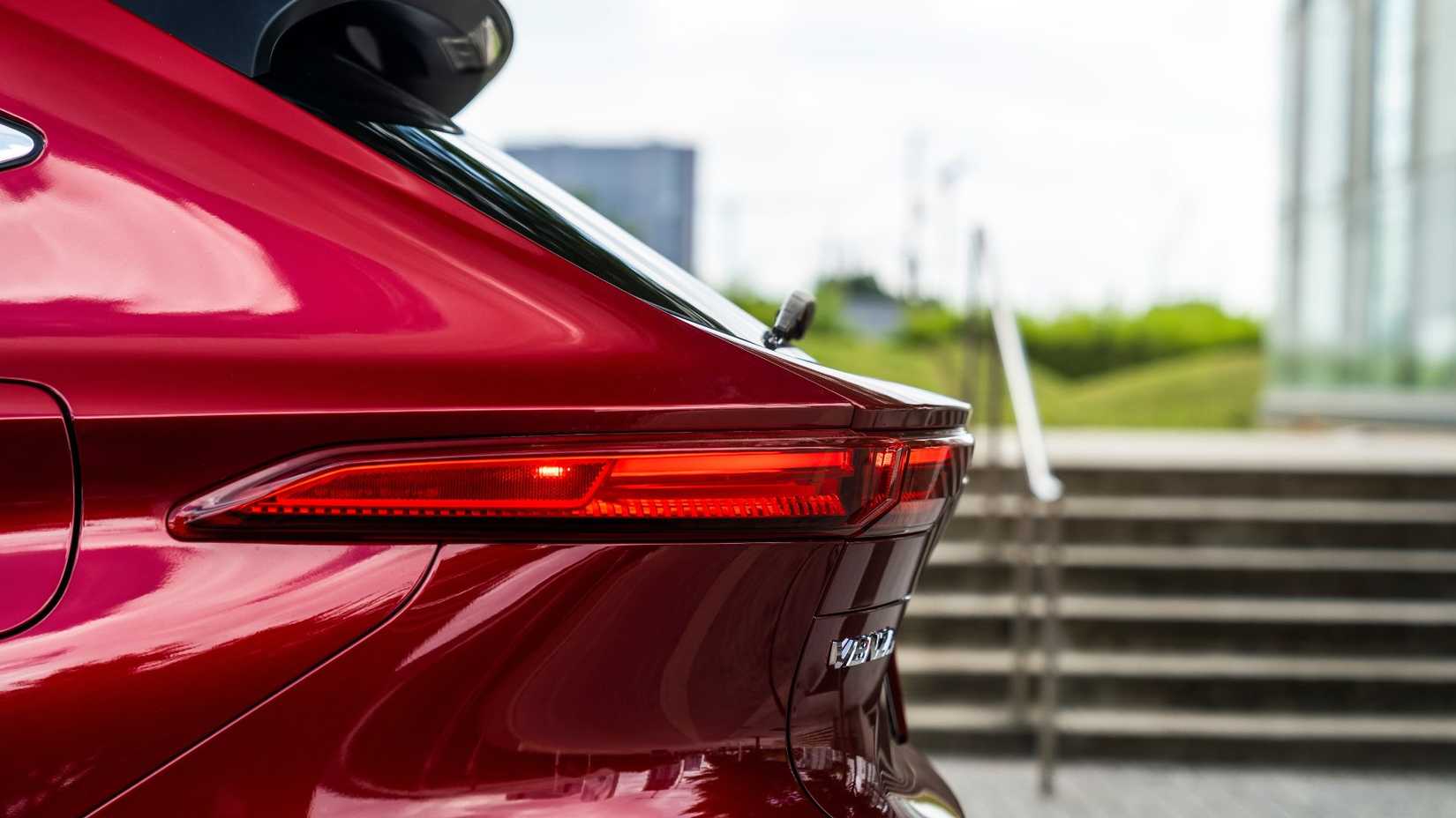 Close-up shot of the rear 1/4 on a red 2022 Toyota Venza LE.