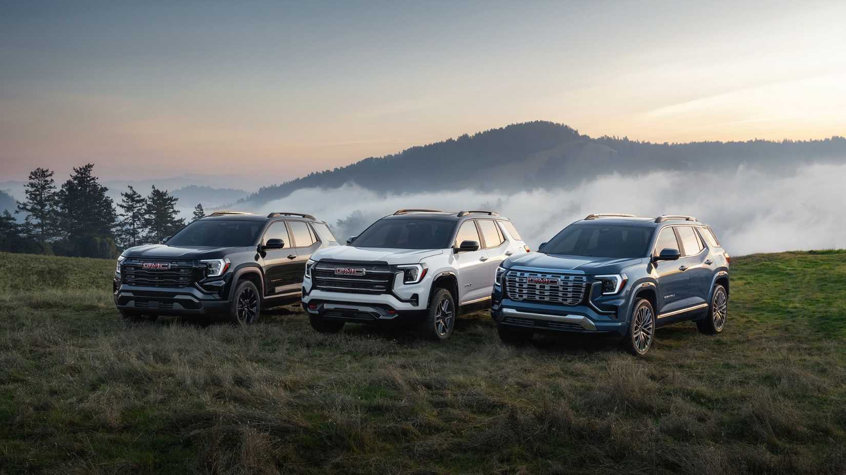 Overview of the next-generation GMC Terrain lineup, including Elevation in Ebony Twilight Metallic, AT4 in Summit White and Denali in Downpour Metallic, from left.