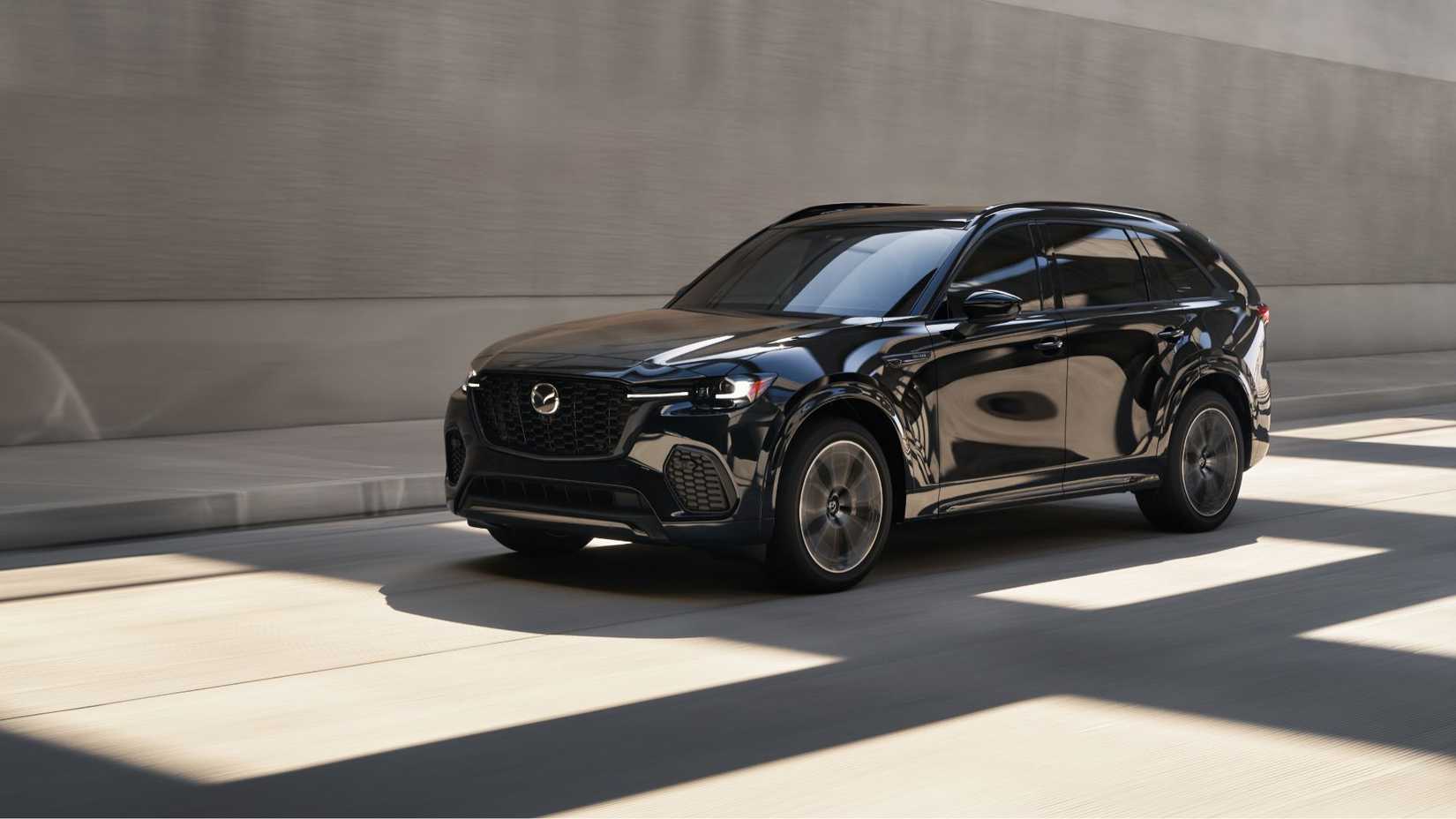 Dynamic front 3/4 shot of a black 2026 Mazda CX-70.