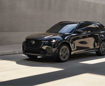 Dynamic front 3/4 shot of a black 2026 Mazda CX-70.