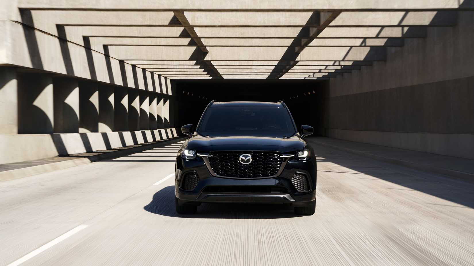 Dynamic front-end shot of a black 2026 Mazda CX-70.