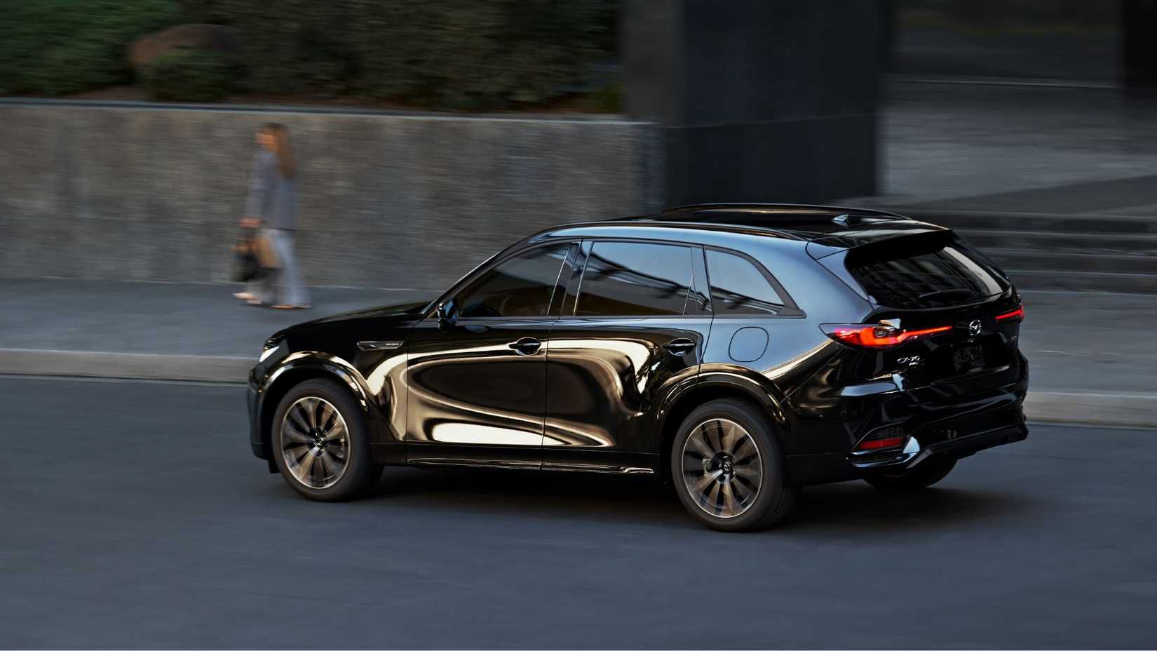 Dynamic rear 3/4 shot of a black 2026 Mazda CX-70.