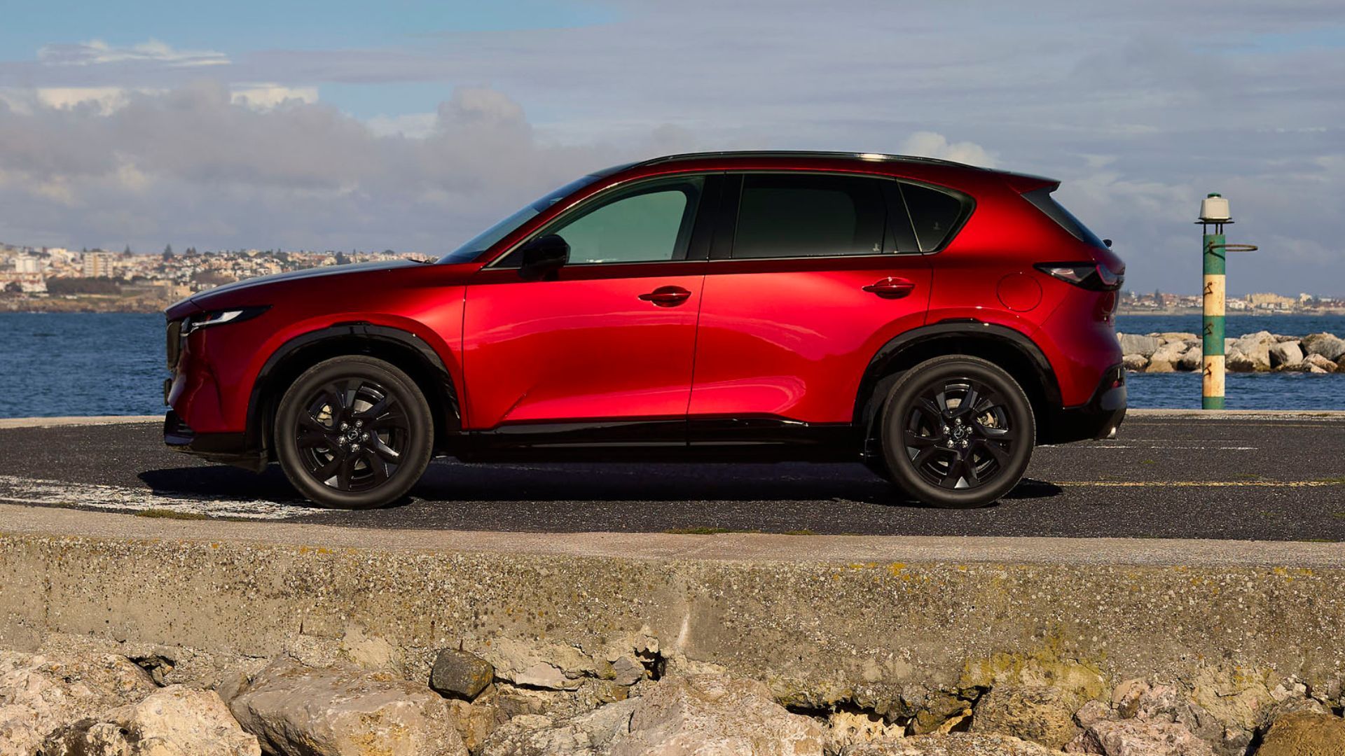 Static side profile shot of a red 2026 Mazda CX-5.