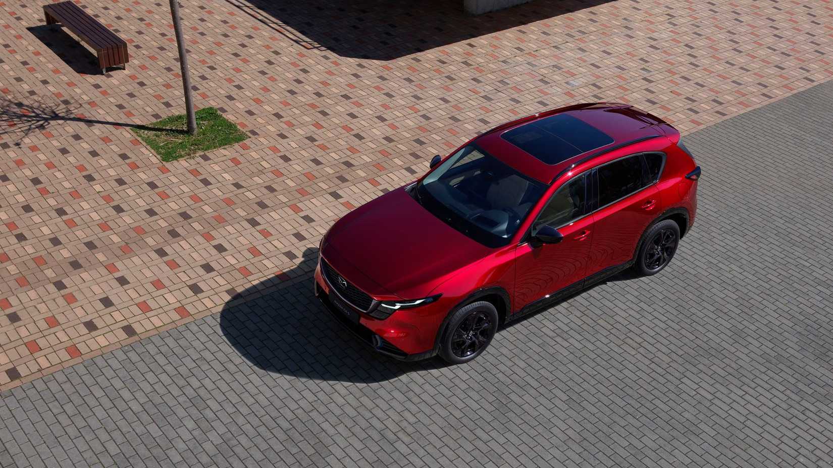 Static overhead front 3/4 shot of a red 2026 Mazda CX-5.