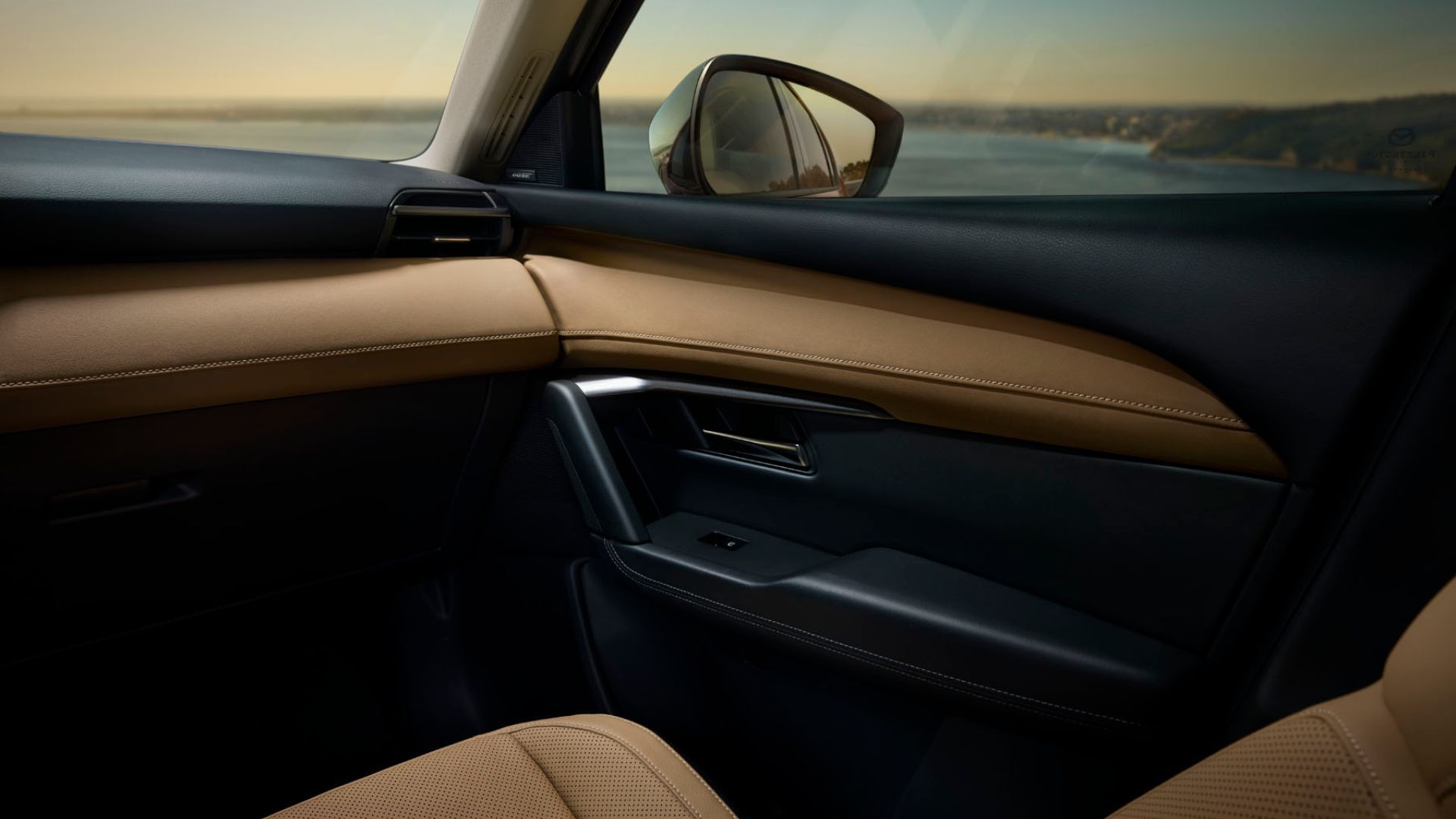 Close-up shot of the door trim inside the cabin of a 2026 Mazda CX-5.