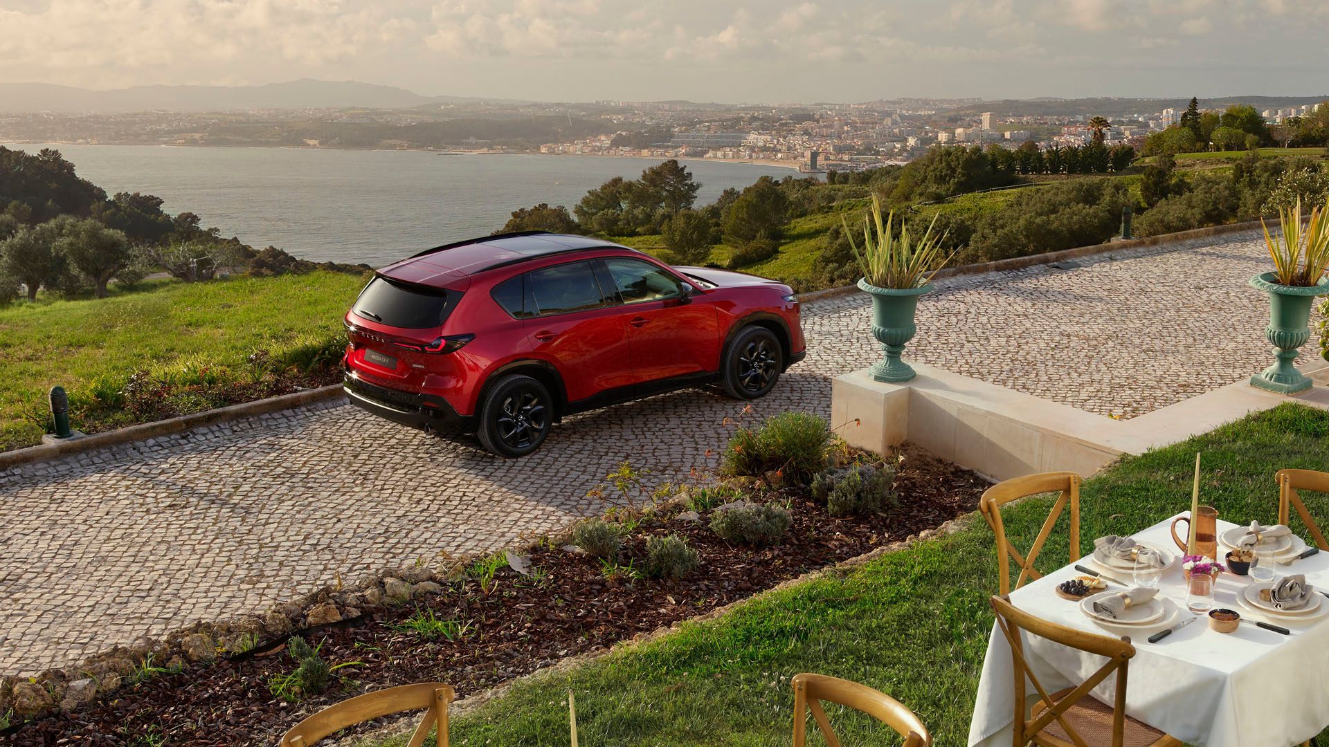 Static overhead rear 3/4 shot of a red 2026 Mazda CX-5.