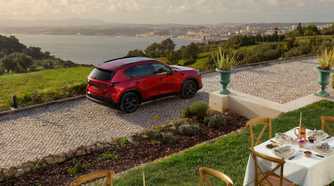 Static overhead rear 3/4 shot of a red 2026 Mazda CX-5.