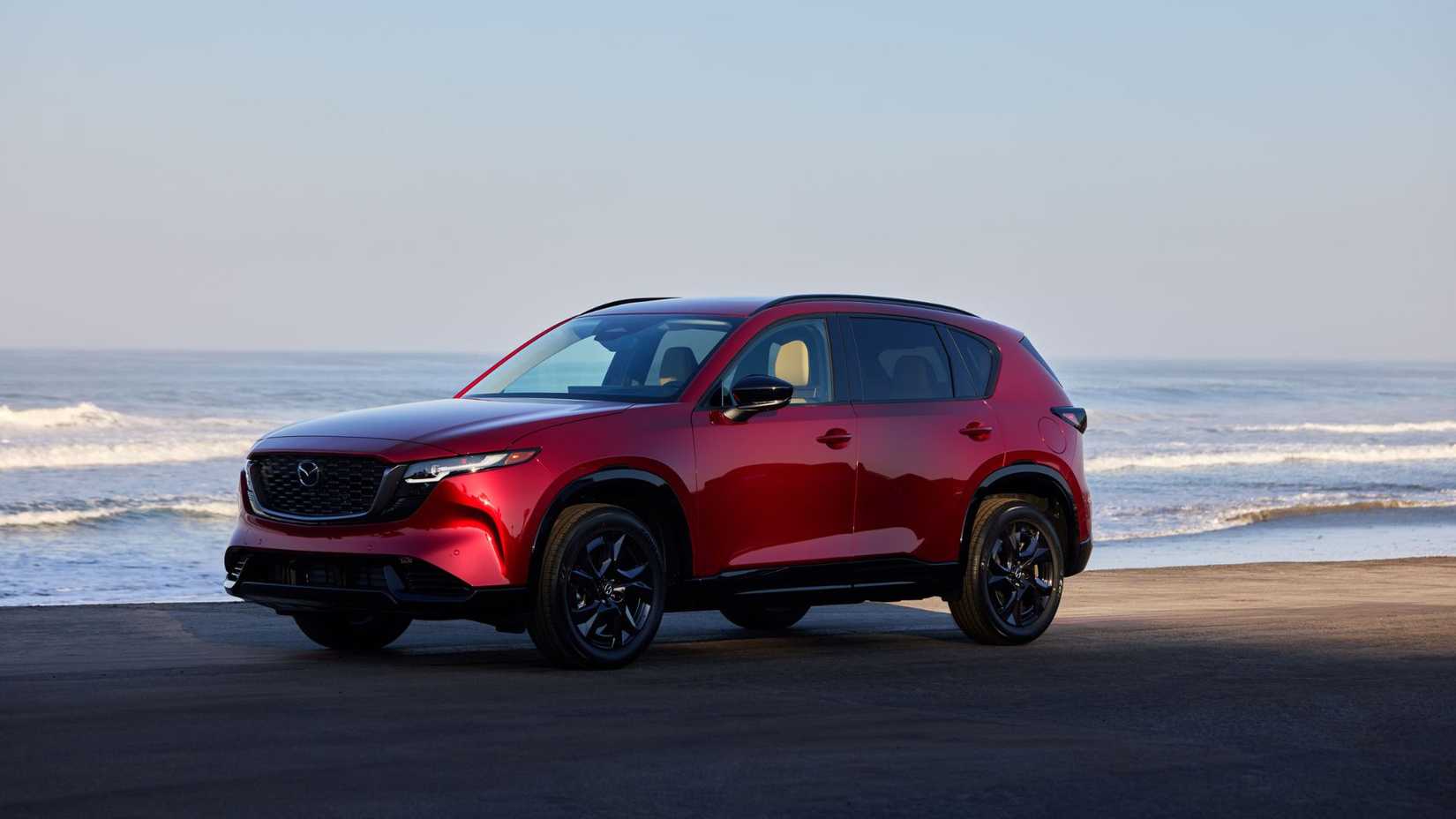 Static front 3/4 shot of a red 2026 Mazda CX-5.