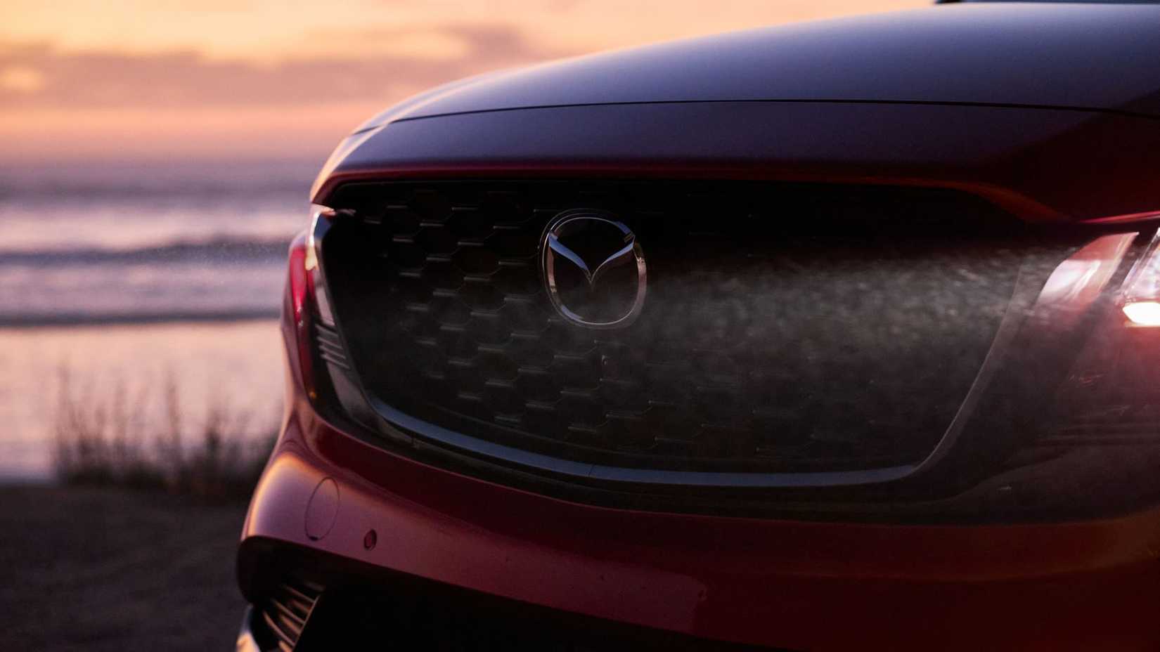 Close-up shot of the grille on a red 2026 Mazda CX-5.