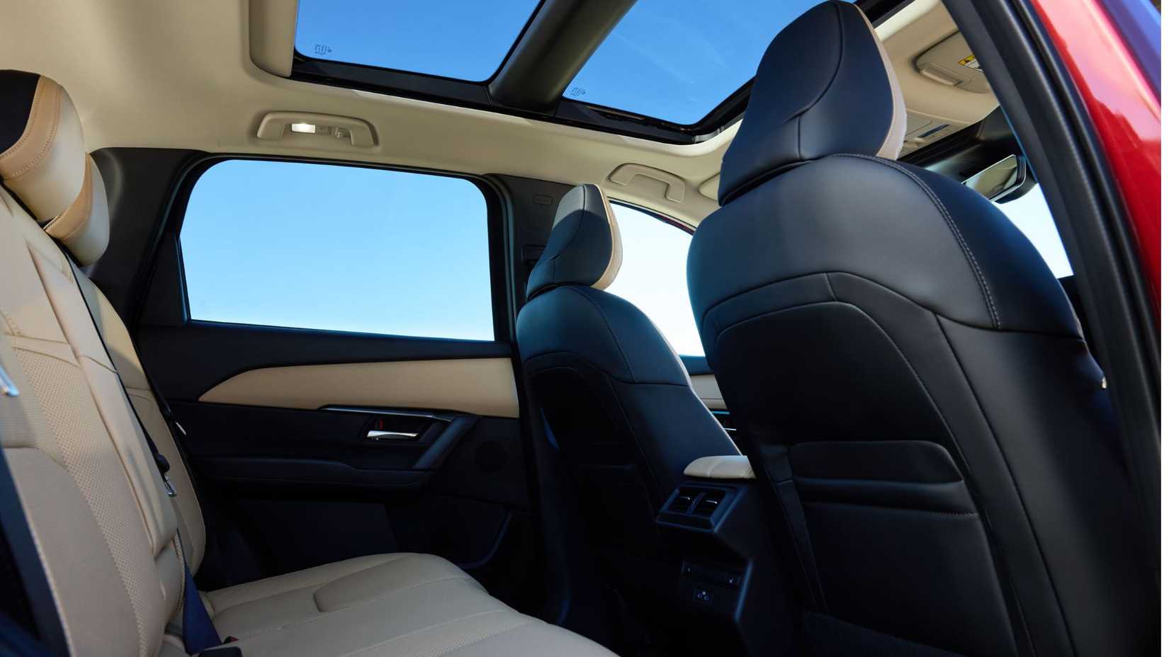 Shot of the rear seats and panoramic sunrood inside the cabin of a 2026 Mazda CX-5.
