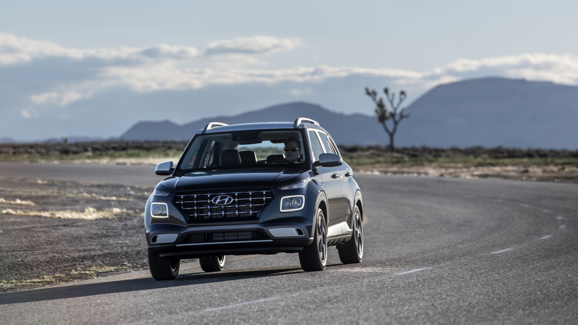 Dynamic front-end shot of a blue 2025 Hyundai Venue.