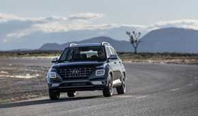 Dynamic front-end shot of a blue 2025 Hyundai Venue.