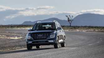 Dynamic front-end shot of a blue 2025 Hyundai Venue.