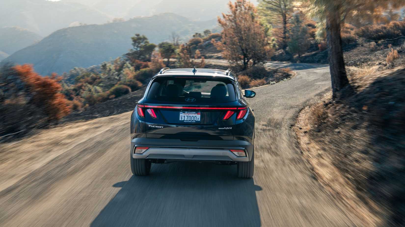 Dynamic shot of the rear of a black 2026 Hyundai Tucson Hybrid.