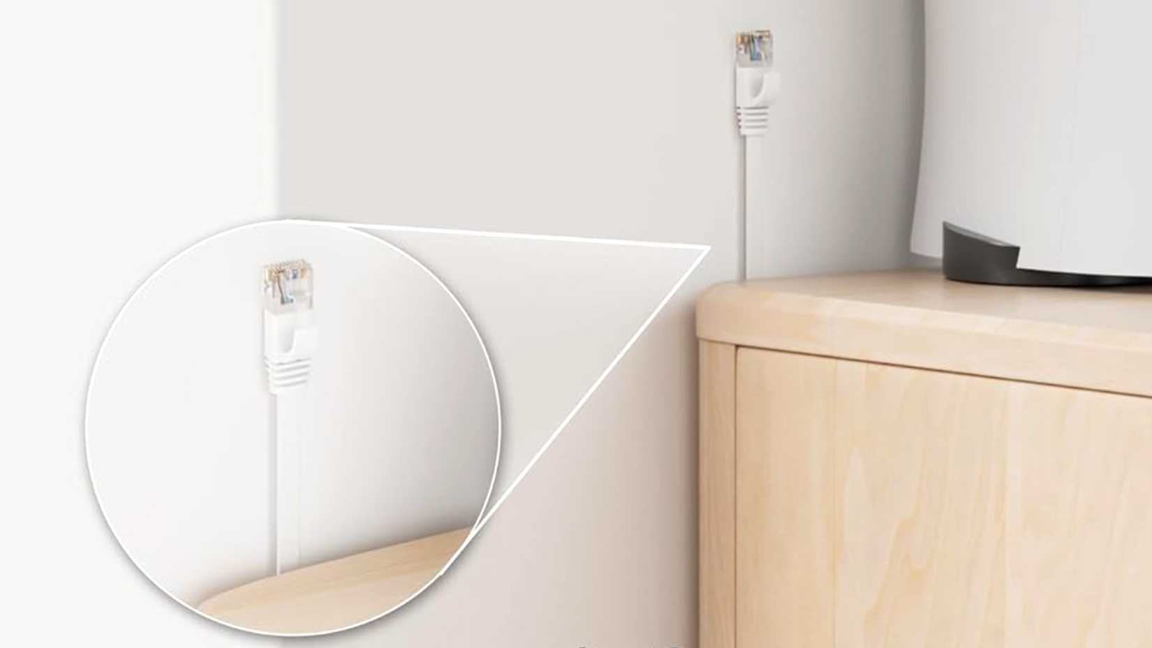 A flat ethernet cable going into the wall and to a PS5