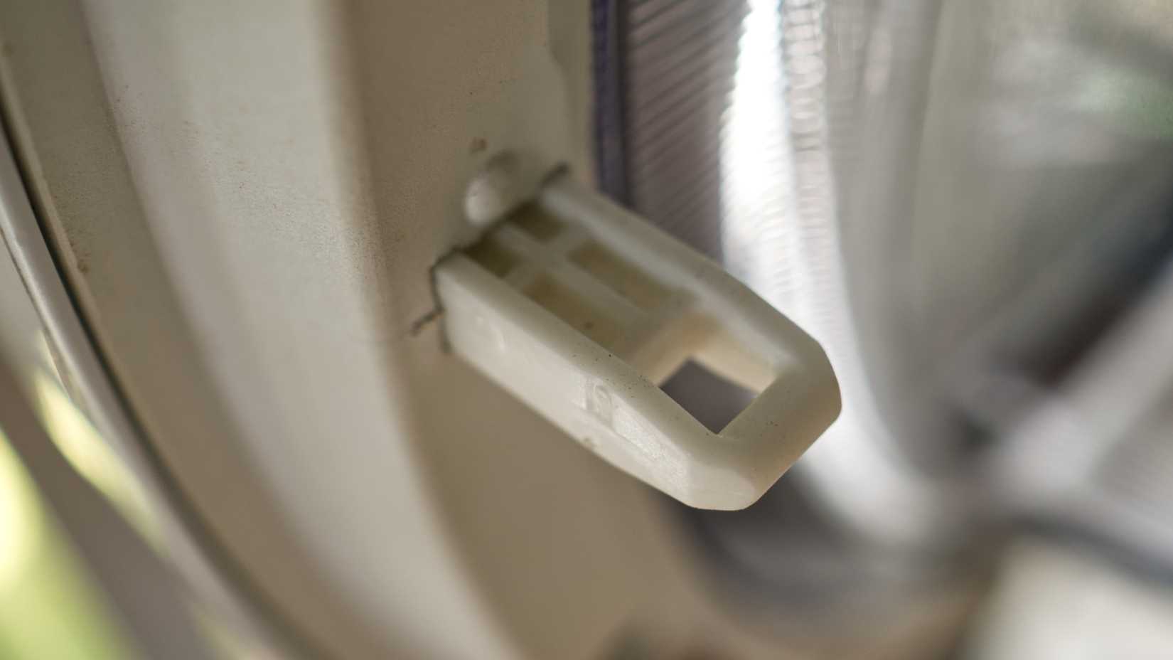 A flimsy plastic catch on a dryer.-1