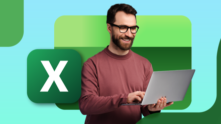 A man looking happy while holding a laptop running Excel.