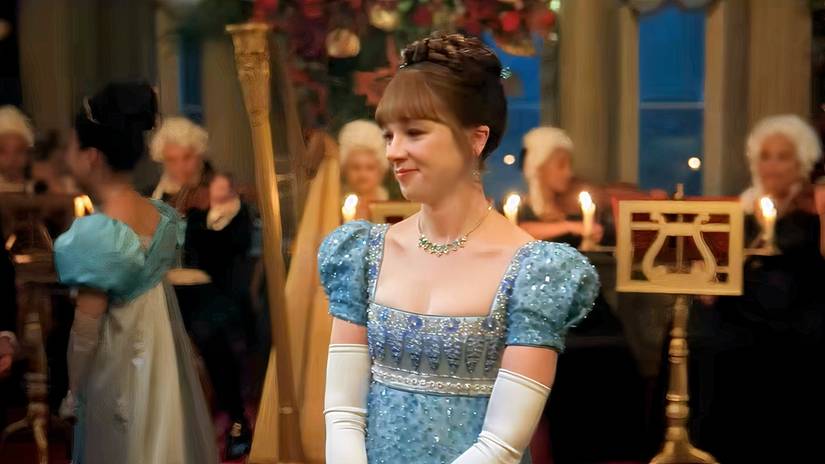 Eloise smiling at a ball in Bridgerton Season 4. 